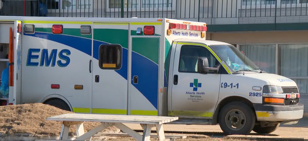 Ambulance marked with Alberta Health Services logo.